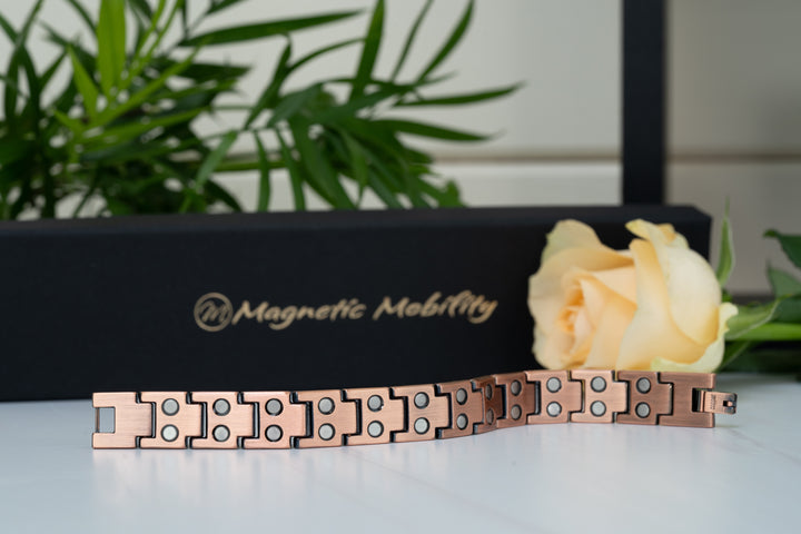 Back view of Alexander's Copper Magnetic Bracelet laid flat, revealing the strategically placed double-strength neodymium magnets on every link.