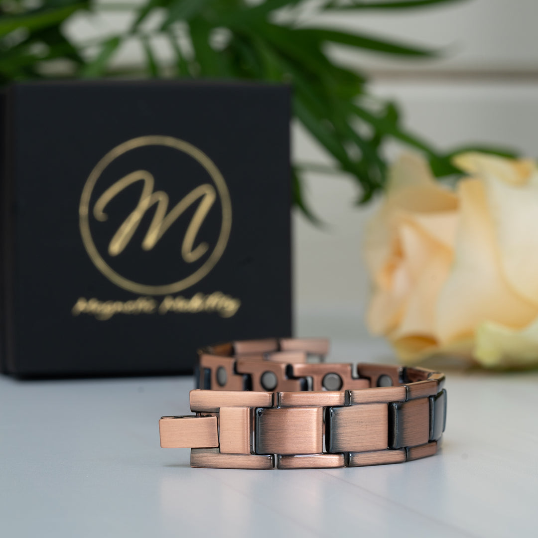Alexander's Copper Magnetic Bracelet arranged in a flexible snake-like shape, revealing the double-strength neodymium magnets on each link.