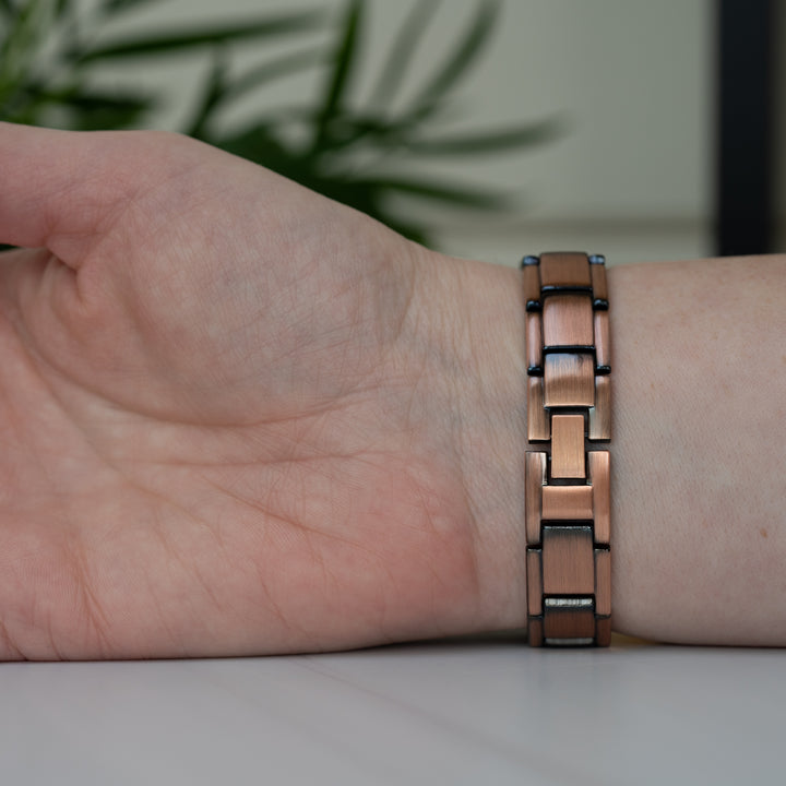 Alexander's Copper Magnetic Bracelet worn on a wrist, showing the secure clasp and sophisticated copper link design