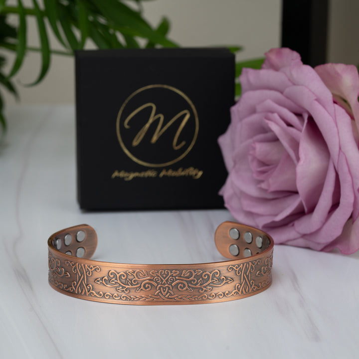 front-angle shot of the Campion Copper Bracelet, featuring its triple-strength 18 magnets and 99.9% pure copper material. The intricate detailing of the floral-inspired pattern stands out prominently.