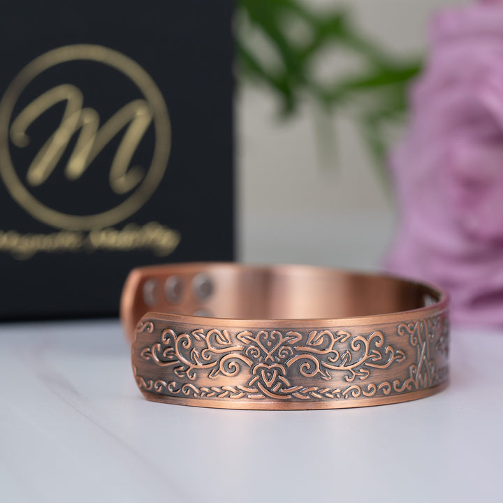 Side profile of the Campion Copper Bracelet, showcasing its robust 15mm width and intricate design. The magnets are subtly visible on the inner side.