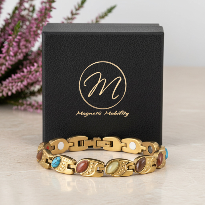 Gold magnetic bracelet with colorful stones on a black box with 'Magnetic Mobility' logo