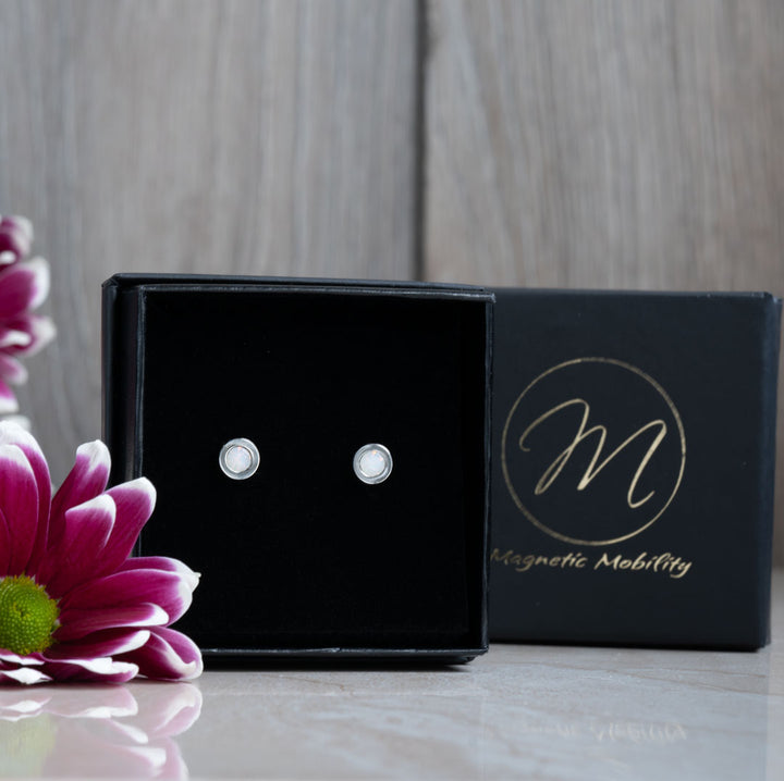 Chic June Birthstone magnetic earrings with Swarovski Pearls, presented in a black box with a pink flower backdrop. The earrings are designed for elegance and therapeutic benefits, making them a thoughtful gift for June birthdays.