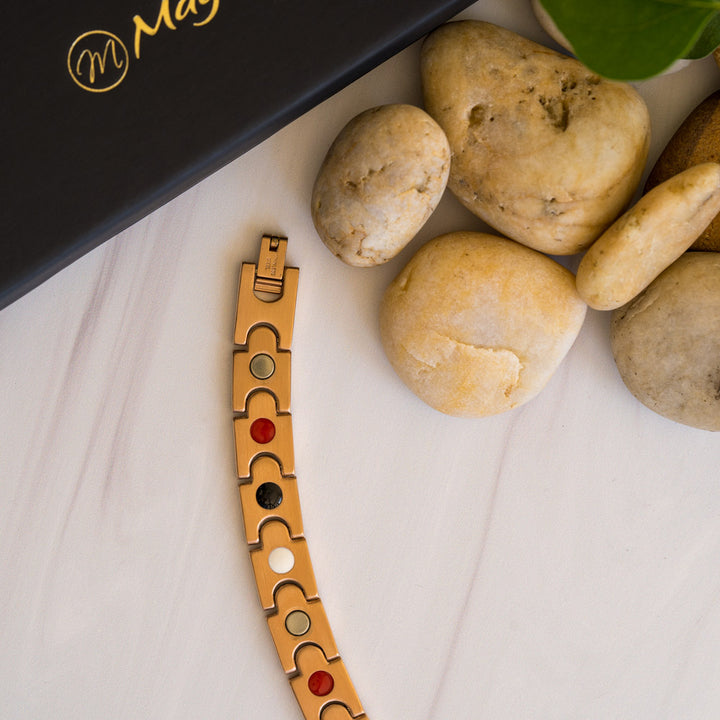 The back view of the Rowan Dawn men's bracelet showcases four embedded health elements: Neodymium magnets, Germanium, Negative ions, and FIR (Far Infrared) components. These elements blend seamlessly with the bracelet's rose gold stainless steel design. This dual-purpose accessory combines style with benefits for conditions like arthritis, back pain, and migraines.