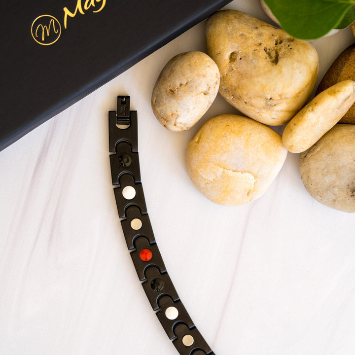 Back view of the Rowan Night Men's Black 4in1 Magnetic Bracelet, offering a glimpse of the beautifully crafted design with interconnected pieces, highlighted by the striking black stripe. Explore the embedded elements of Neodymium magnets, Germanium, Negative ions, and Far Infrared (FIR) components, seamlessly integrated into the bracelet's design.