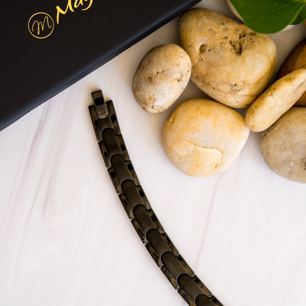 Top-down view of the Rowan Night Men's Black 4in1 Magnetic Bracelet, showcasing its sleek design with interconnected pieces and a captivating black stripe