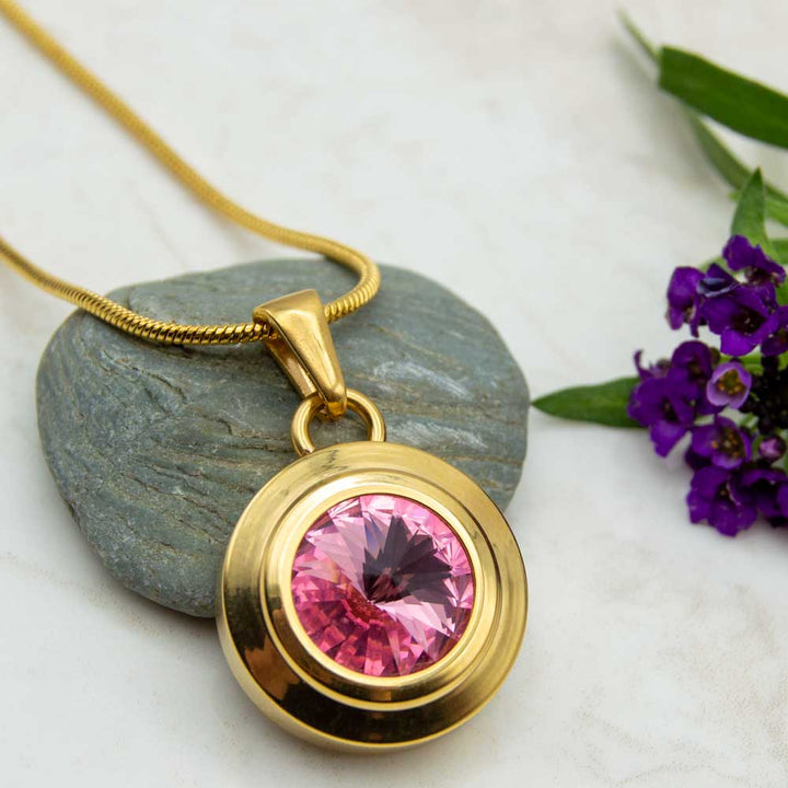 Front view of the Angelica Sun gold plated necklace with a pink Swarovski stone .