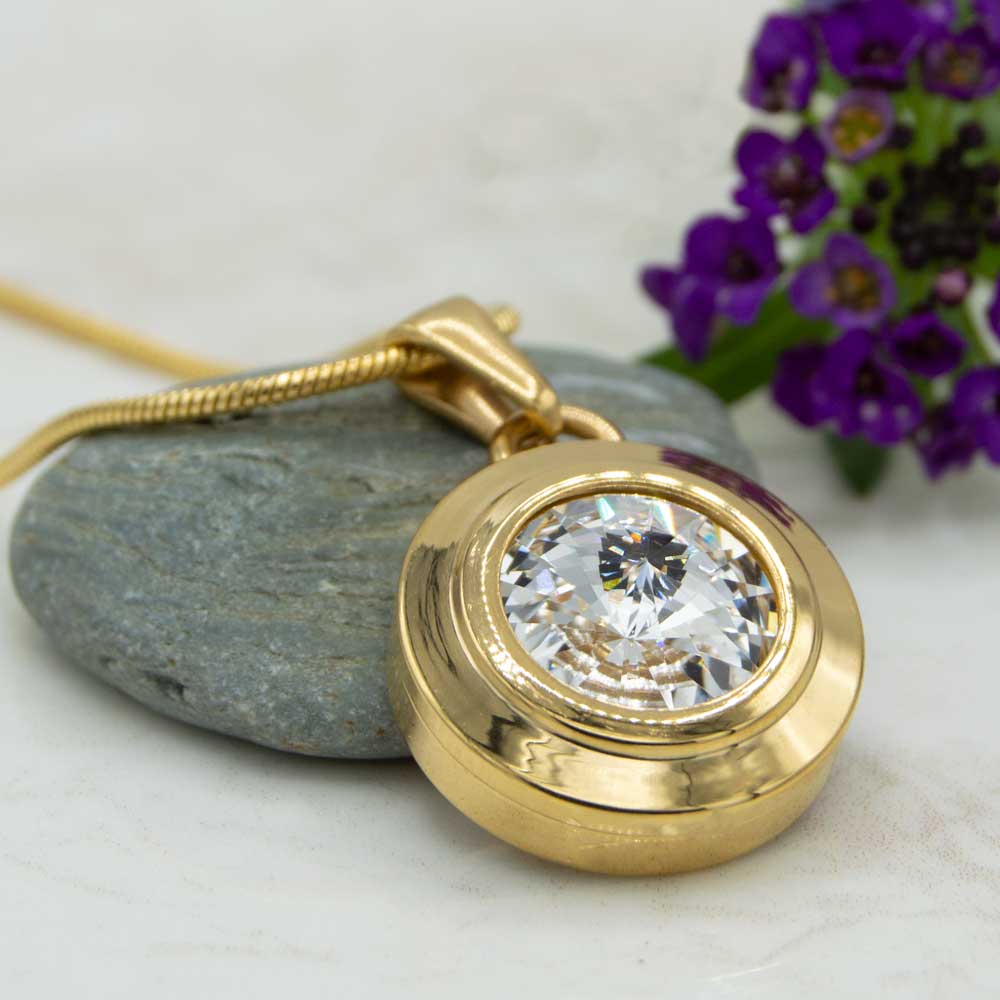 Angelica Sun Magnetic necklace. Front view of the necklace which is a gold plated magnetic necklace with a white Swarovski stone