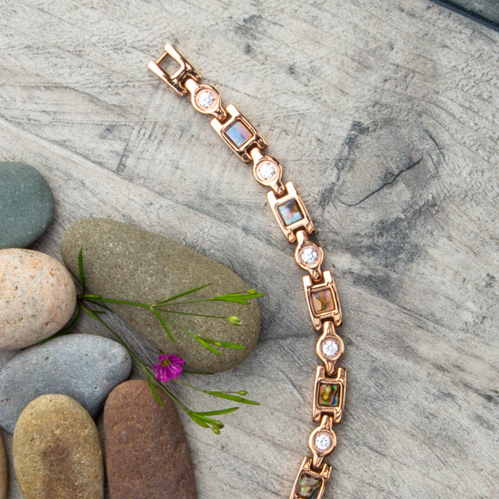 Top view of Avens Dawn Magnetic Bracelet. Shows the irredessant designs and white crystals.