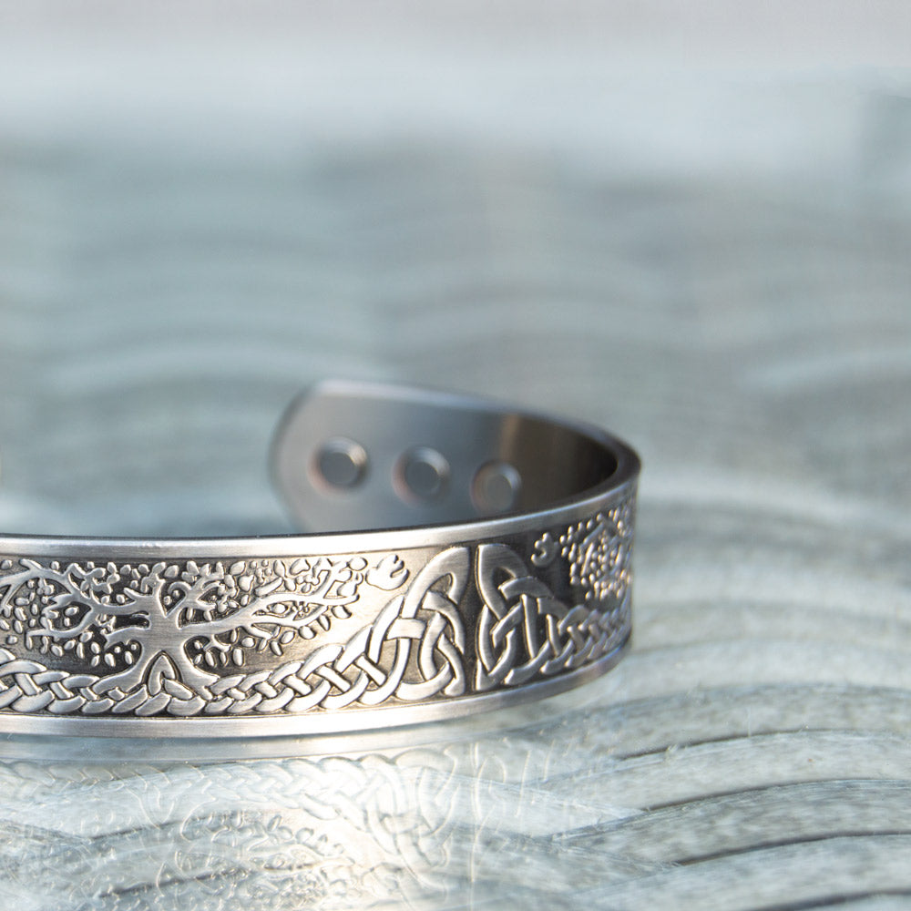 Close up detail of Buckthorn - Mens Silver Copper BangleClose-up image of the silver-plated Buckthorn Copper Bracelet emphasising the intricate Tree of Life design, offering a fashionable solution for pain relief.