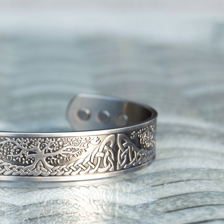 Close up detail of Buckthorn - Mens Silver Copper BangleClose-up image of the silver-plated Buckthorn Copper Bracelet emphasising the intricate Tree of Life design, offering a fashionable solution for pain relief.