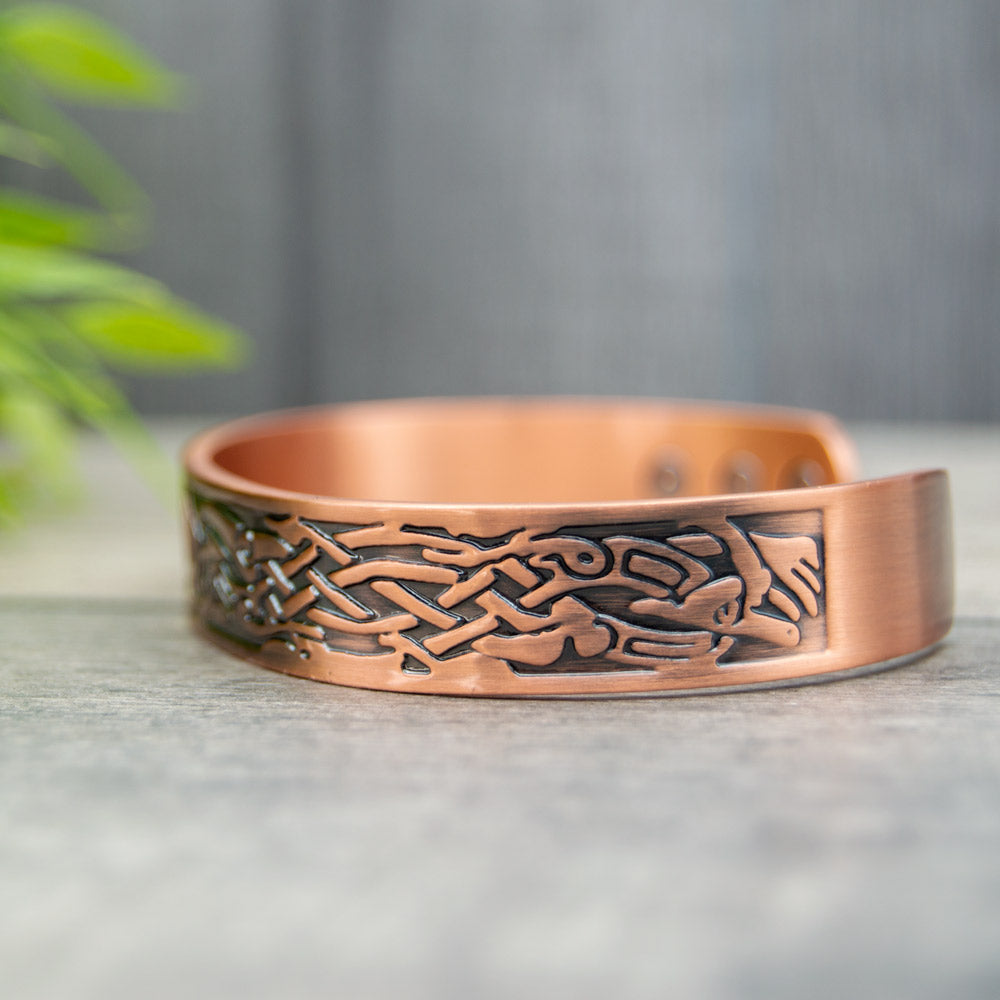 Side view of the open backed copper bangle with a beautiful Irish design