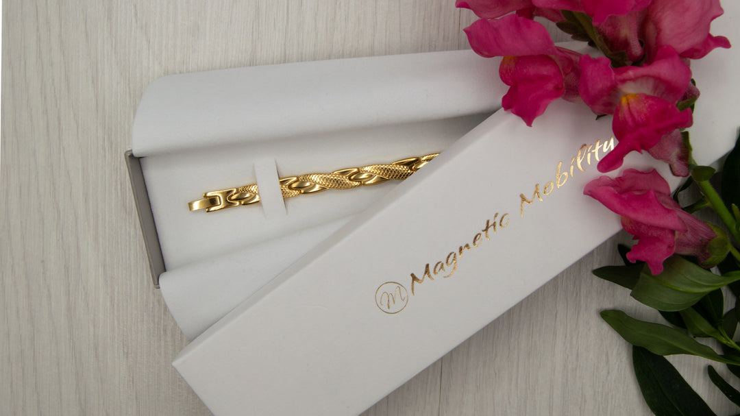 Women's Gold colour 4in1 Health Elelement Magnetic Bracelet.  Top view of the bracelet in a Luxury white gift box for Jewellery from Magentic Mobility.