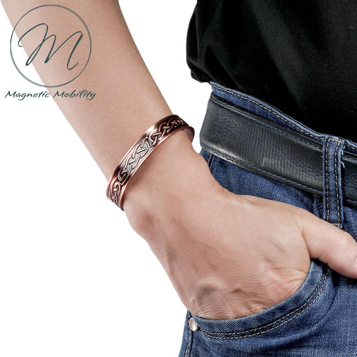 On arm view of Celtic design copper bracelet with 6 Neodymium Magnets to help with arthritis pain, back pain ect.