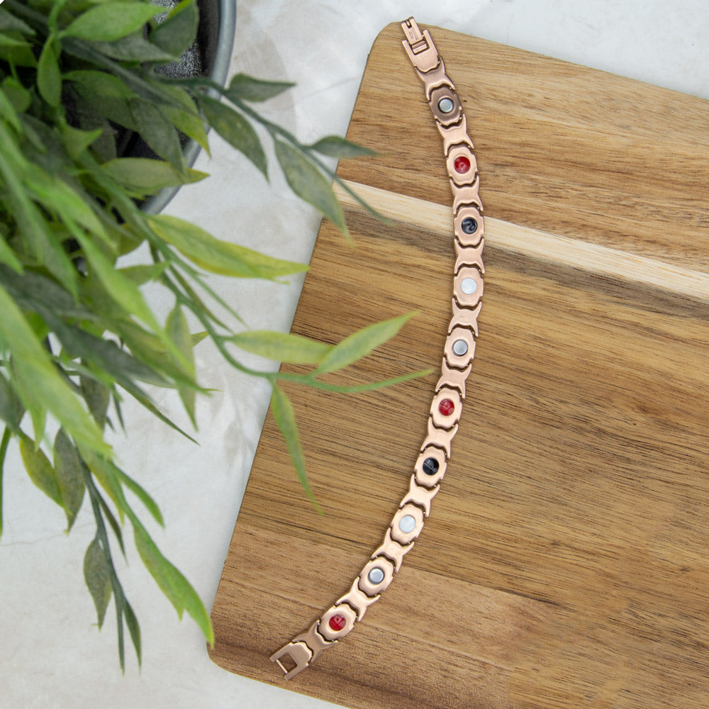 Back view of Willow Dusk - Womens Rose gold coloured magnetic bracelet with opals and white crystals. The image shows the 4 health elements on the back - Neodynium Magnets, Germanium, FIR elements and Negative ions.