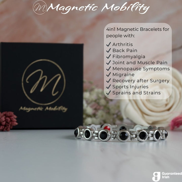 Front view of the Angelica in Black 4in1 Magnetic Bracelet from Magnetic Mobility - a black crystal magnetic bracelet for women with back pain, migraine, menopause symptoms and more - shown with gift box and flowers