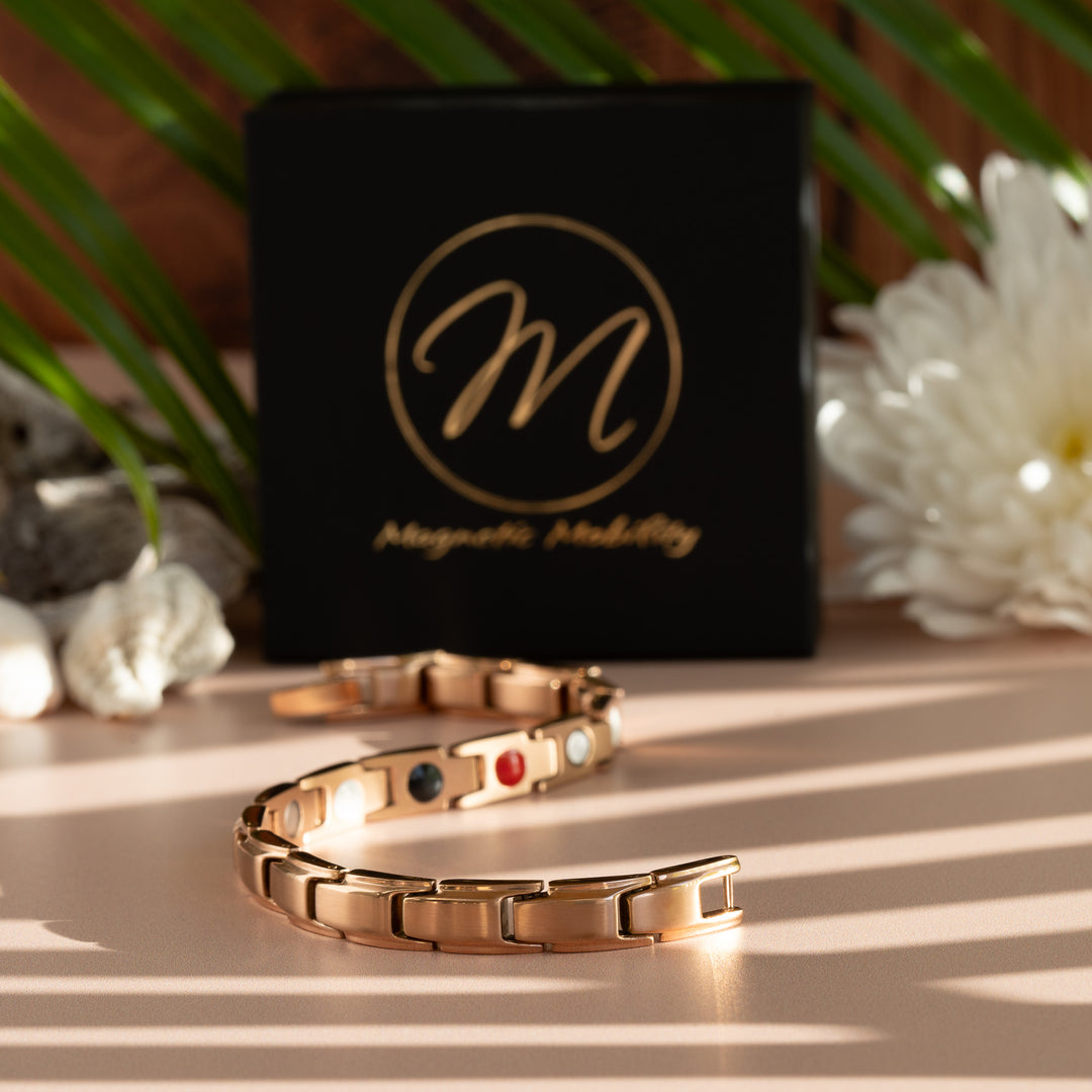 Apia Dawn 4in1 Magnetic Bracelet from Magnetic Mobility - Rose Gold thin Magnetic Bracelet - snake view of bracelet with Magnetic Mobility gift box and flowers