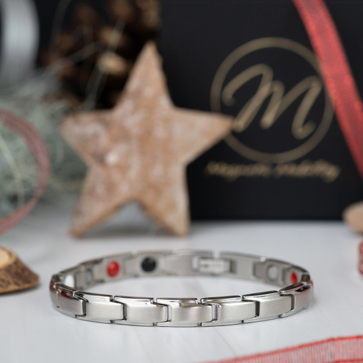 Apia Star 4in1 Magnetic Bracelet from Magnetic Mobility - Thin silver magnetic bracelet shown with Christmas Decorations