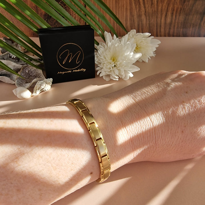 Apia Sun 4in1 Magnetic Bracelet from Magnetic Mobility - a thin gold magnetic bracelet - on a wrist