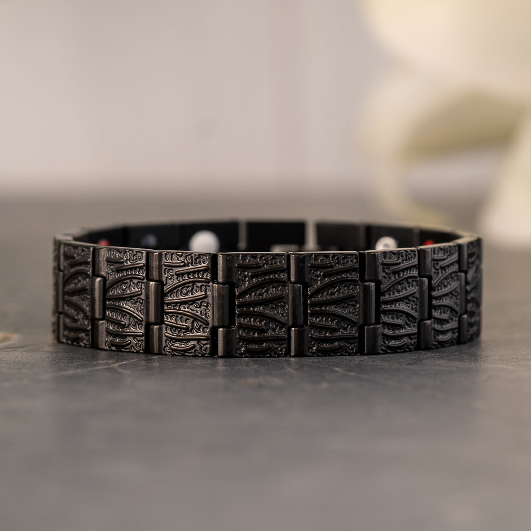 Close-up view of the Burnet Night Magnetic Bracelet showcasing the intricate black stainless steel design and embedded wellness elements.