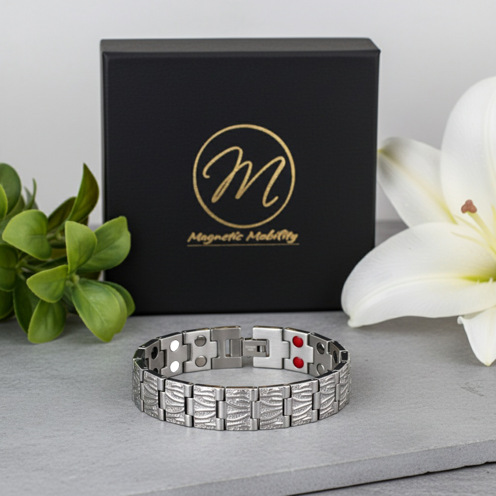 Silvermagnetic bracelet with rdouble elements on a gray surface next to a black box with 'Magnetic Mobility' branding.