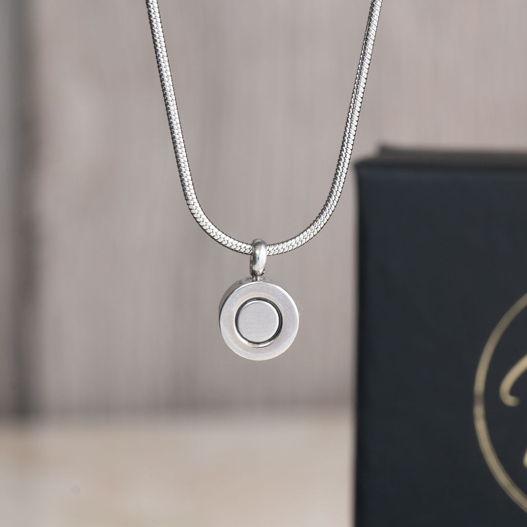 December birthstone magnetic necklace with a snake chain, featuring a minimalist back view of the pendant with a magnetic clasp, displayed against a black background with Magnetic Mobility branding