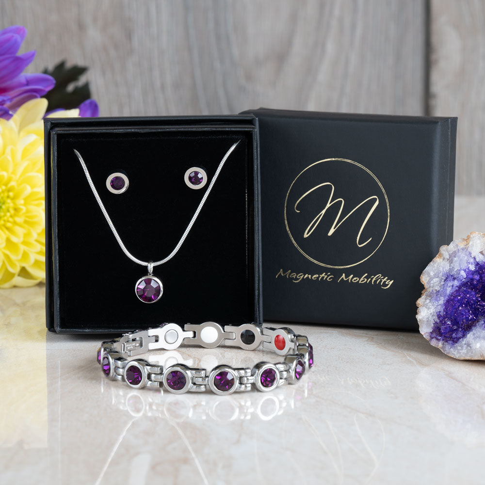 Febraury Birthstone gift set containing a 4in1 Magnetic bracelet with February birthstone Swarovski Amethyst crystals, a February birthstone necklace with one Swarovski Amethyst crystal and a neo-dynimum magnet in the back and a pair of February Birthstone magnetic earrings with Neodynimum magnets in the back. Shown in a black luxury gift box.