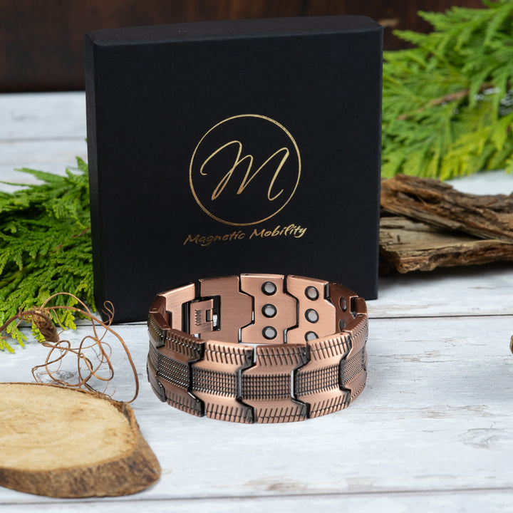  Gentian copper magnetic link bracelet with wide textured links and dark detailing, shown beside a Magnetic Mobility box.