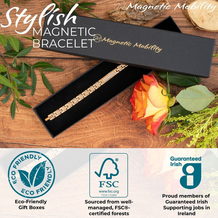 Honesty Dawn - 4in1 Magnetic bracelet with a centerpiece, adorned with two rows of shimmering Swarovski crystals. By Magnetic Mobility. Shown in a black Magnetic Mobility gift box with a rose beside it. Also shows logos of Eco-friendly gift box from FSC paper and members of Guaranteed irish