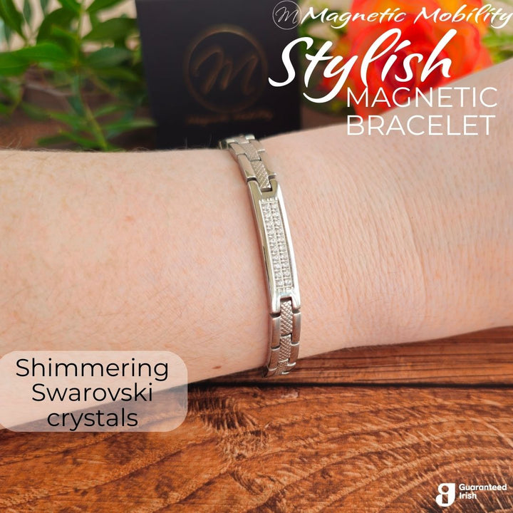 Silver 4in1 Magnetic bracelet from agnetic Mobility with a centerpiece, adorned with two rows of shimmering Swarovski crystals. Bracelet shown on a womans wrist