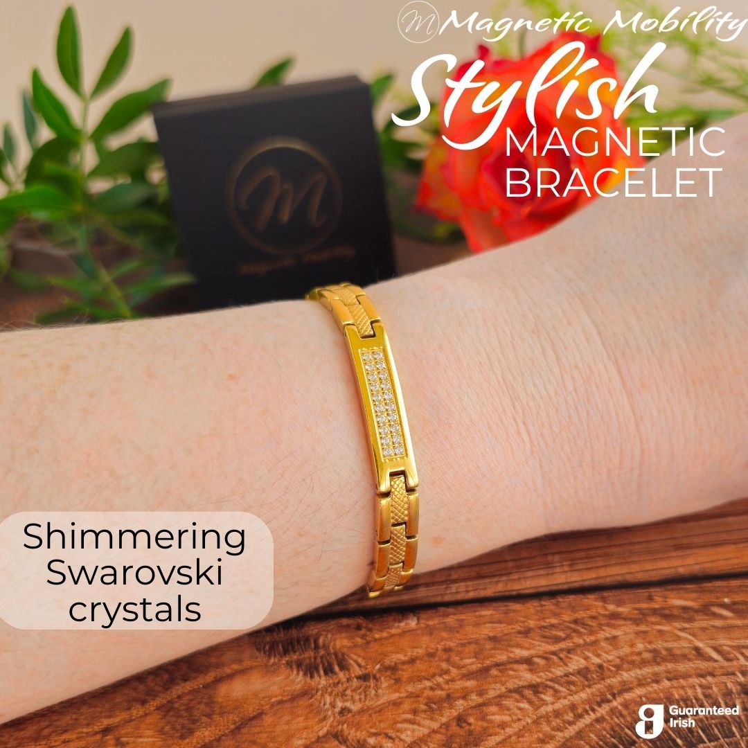 Gold 4in1 Magnetic Bracelet from Magentic Mobility with a centerpiece, adorned with two rows of shimmering Swarovski crystals. Bracelet shown on a womans wrist