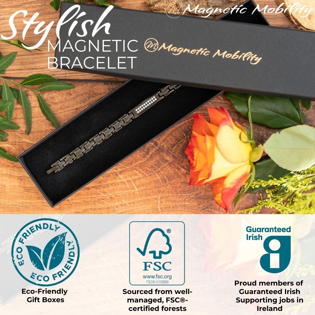 Honesty Night 4in1 Magnetic Bracelet from Magentic Mobility - A black magentic bracelet with a centerpiece, adorned with two rows of shimmering Swarovski crystals.  Top view showing the bracelet in its black gift box with a rose beside it. Logos showing Eco-Friendly Gift boxes and feauting the Guaranteed irish symbol