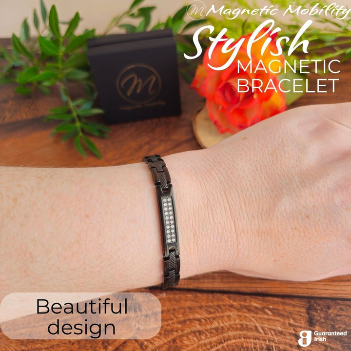 Honesty Night 4in1 Magnetic Bracelet from Magentic Mobility - A black magentic bracelet with a centerpiece, adorned with two rows of shimmering Swarovski crystals. Shown on a womans wrist