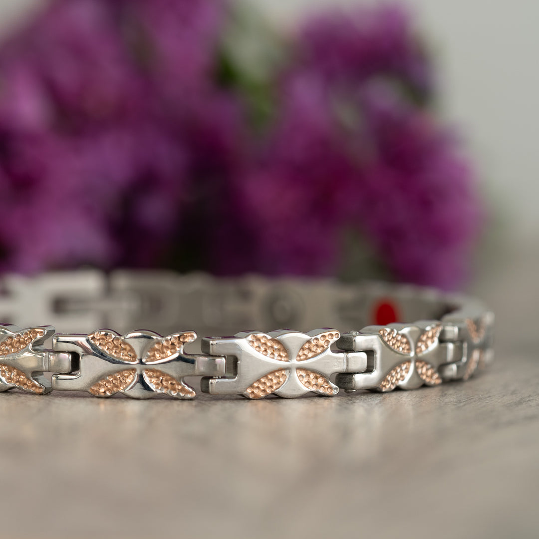 Detailed close-up of the Meadowsweet Dusk 4in1 Magnetic Bracelet’s silver and rose gold butterfly design, showcasing the stylish finish.