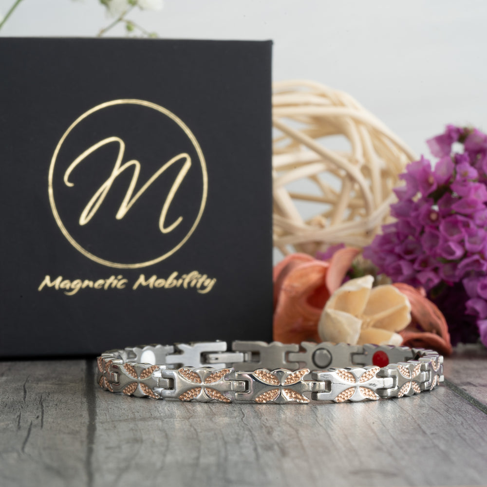 Front view of the Meadowsweet Dusk 4in1 Magnetic Bracelet by Magnetic Mobility, featuring a delicate butterfly design in silver and rose gold.