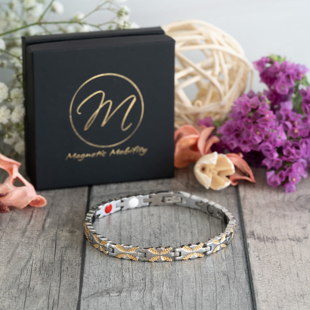 Meadowsweet Moon 4in1 Magnetic Bracelet by Magnetic Mobility in a sleek 45-degree view. Showcasing its silver and gold butterfly design and therapeutic elements, including Neodymium magnets, FIR elements, Germanium, and Negative Ions, for pain relief and joint support.