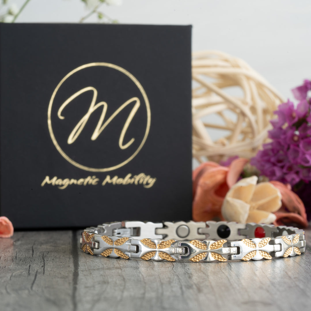 Front view of the Meadowsweet Moon 4in1 Magnetic Bracelet, a stylish silver and gold butterfly design bracelet by Magnetic Mobility. Offers therapeutic benefits for arthritis, joint pain, and back pain with its Neodymium magnets, FIR elements, Germanium, and Negative Ions."