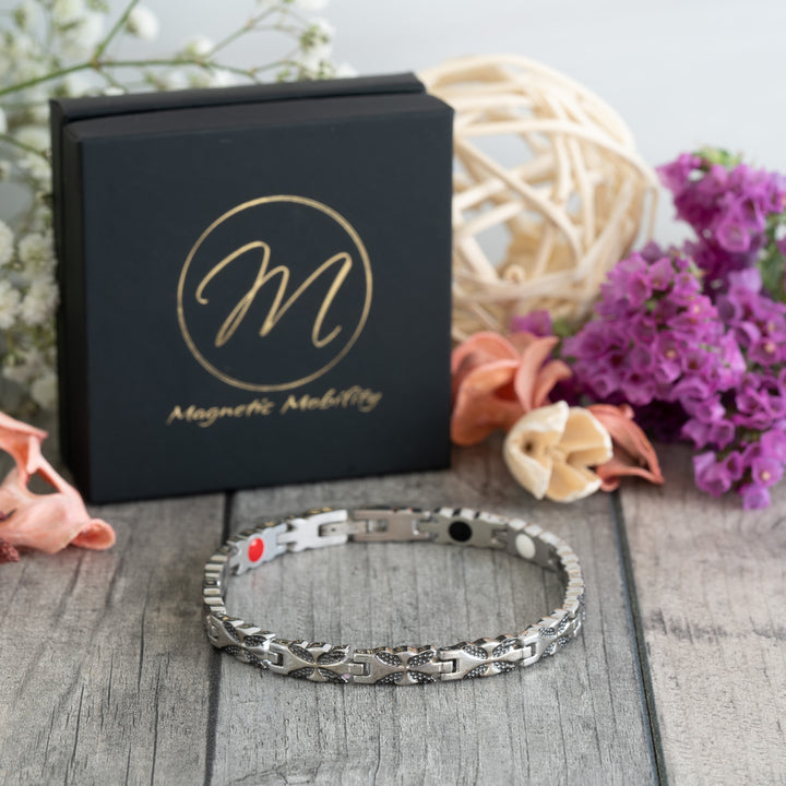 Meadowsweet Night 4in1 Magnetic Bracelet displayed at a 45-degree angle, highlighting its silver and black butterfly design and stylish finish