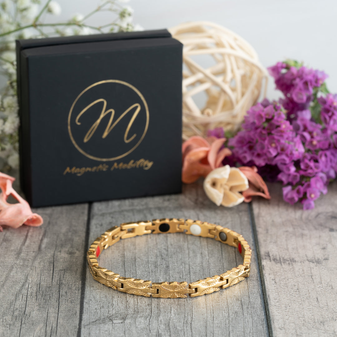 Meadowsweet Sun 4in1 Magnetic Bracelet displayed at a 45-degree angle, highlighting the gold butterfly design and its stylish finish.