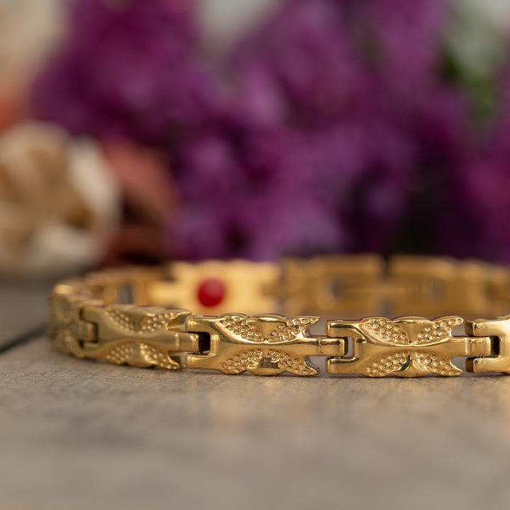 Close-up of the Meadowsweet Sun 4in1 Magnetic Bracelet by Magnetic Mobility, showcasing its intricate gold butterfly design for arthritis relief and joint pain.