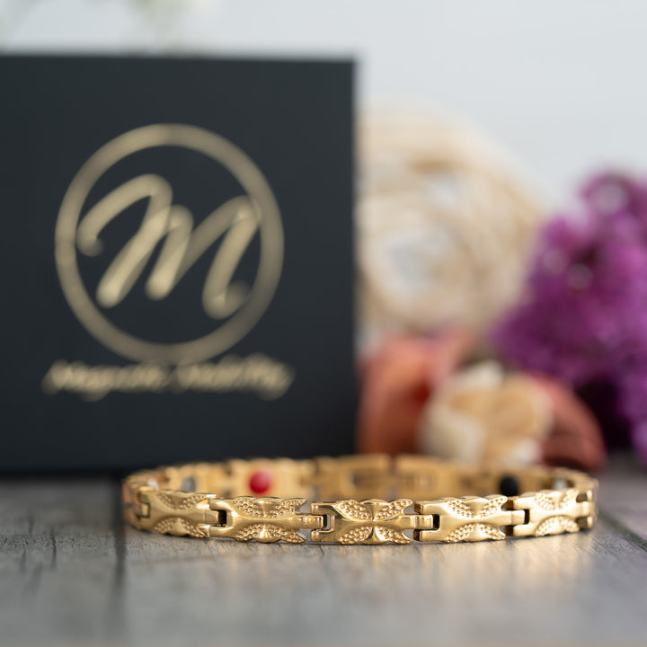 Front view of the Meadowsweet Sun 4in1 Magnetic Bracelet by Magnetic Mobility, featuring a delicate gold butterfly design and health elements.