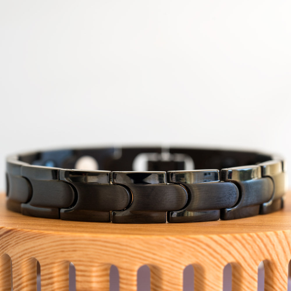 Close-up view of the Rowan Night Men's Black 4in1 Magnetic Bracelet, highlighting its intricate details and the captivating black stripe, adding an elegant touch to the sleek stainless steel design