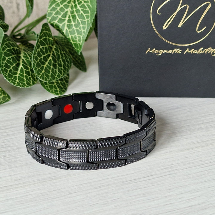 Another angled view of Gentian Night Magnetic Bracelet, highlighting its sleek all-black design and wellness-boosting 4in1 elements.