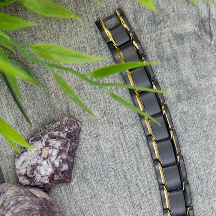 Top view of Alexanders Dawn - Mens Magnetic Bracelet - Black with Gold Stripes