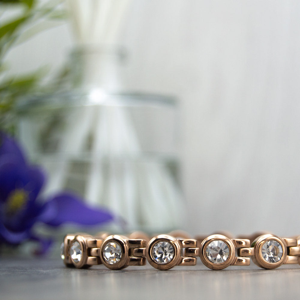 Rose Gold Plated Magnetic Bracelet with White Swarovski Stones and 4in1 Magnetic Technology. Sleek 8mm band width for style and function. Hypoallergenic and tarnish-resistant stainless steel with easy re-sizing tool. Experience magnetic therapy benefits now.