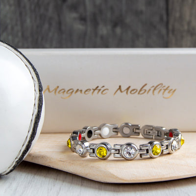 Antrim County GAA Inspired Women's Magnetic Bracelet on a hurl, combining county pride with magnetic therapy benefits for relief from migraines, sports injuries, fibromyalgia, and more. A fashionable accessory for daily wear or special occasions.