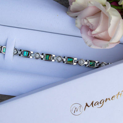 Top view of Avens Moon Magnetic Health bracelet in a white luxury gift box with roses. 