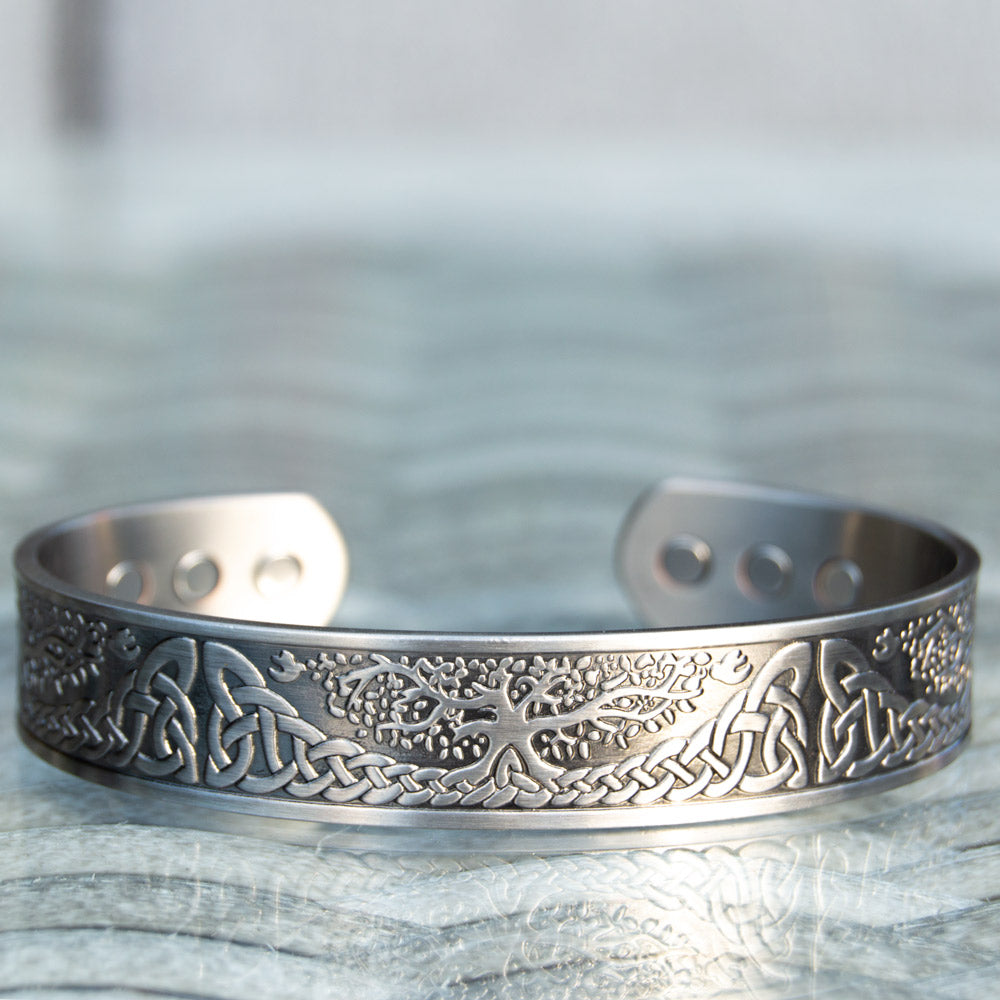 Front view of the silver-plated Buckthorn Copper Bracelet depicting the unique Tree of Life design, a symbolic aid for arthritis.