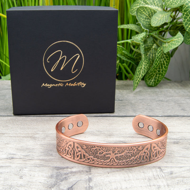 Unique 45-degree angle view of the thick Buckthorn Copper Bracelet showcasing the powerful neodymium magnets, offering a stylish choice for those seeking pain relief options.