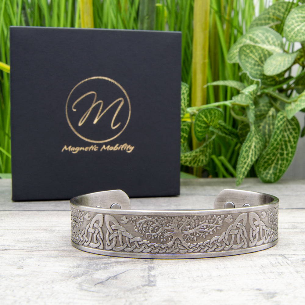 Silver-plated Buckthorn Copper Bracelet adorned with a Tree of Life symbol and Celtic design, a fashionable aid for arthritis relief.
